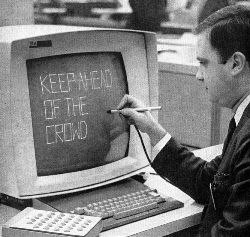 man writing the words keep ahead of the crowd with pen on IBM computer screen from 1964